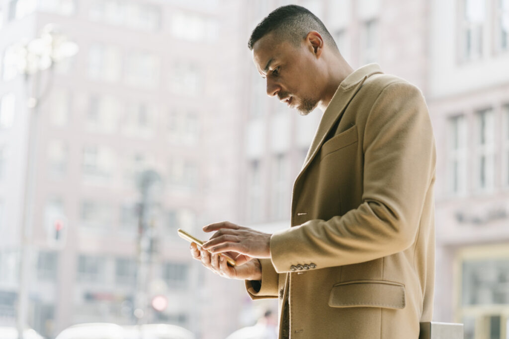 portrait of businessman looking at smartphone 2022 12 16 22 17 11 utc