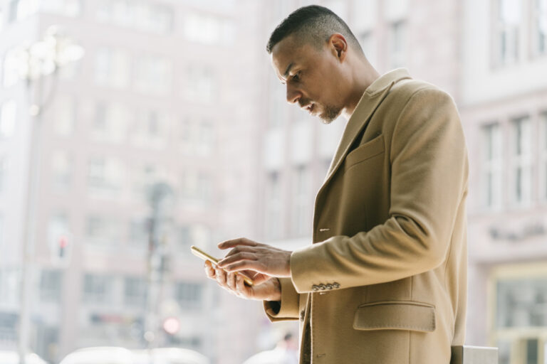 portrait of businessman looking at smartphone 2022 12 16 22 17 11 utc